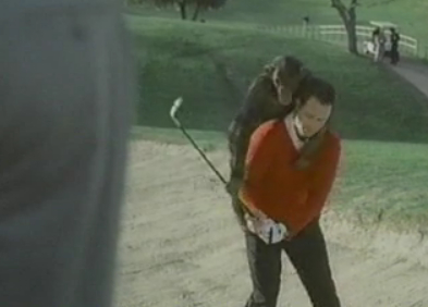 man with monkey on his back playing golf