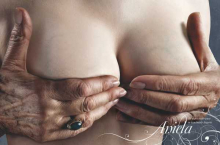 Aniela hand cupping breast ad